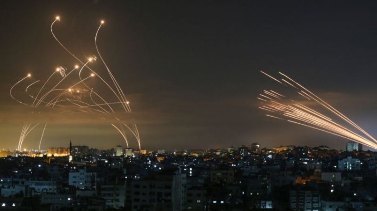 Os mísseis israelenses, à esquerda, lançados para interceptar os foguetes do Hamas, à direita